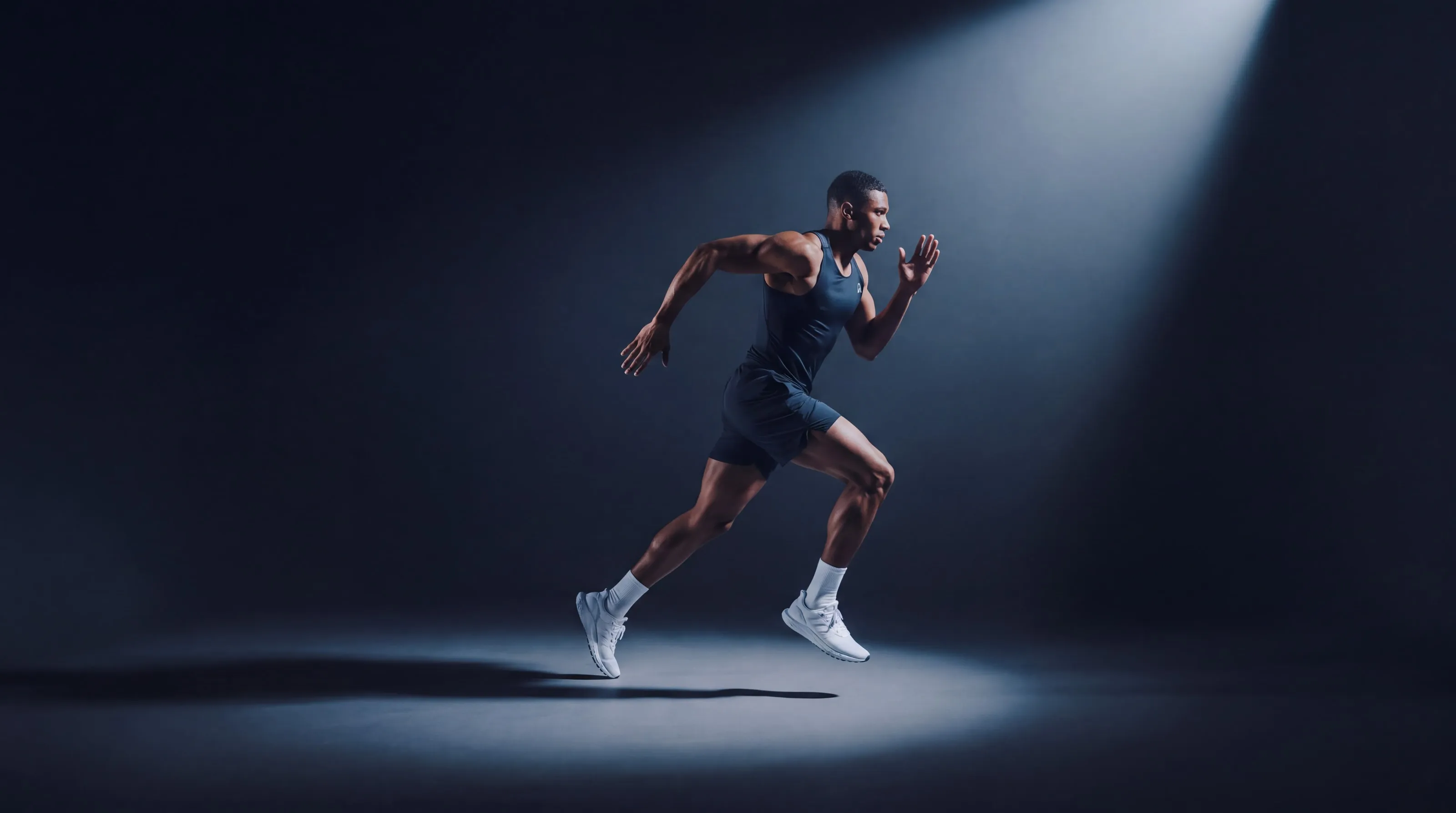 Sprinter training under a spotlight